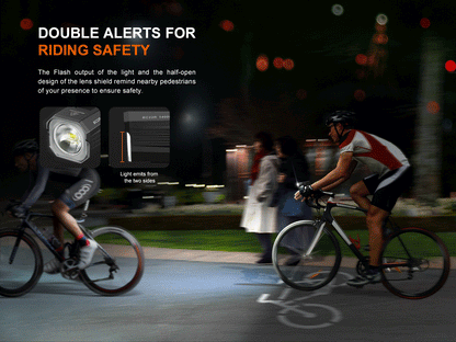cyclist on the road at night signaling with Fenix BC22R Bike Light flashing. 