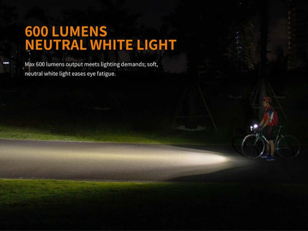 Cyclist at night illuminating road with Fenix BC25R Bike Light. 
