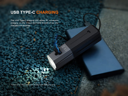 USB Type-C charging Fenix BC22R Bike Light on a textured surface with text about charging time.