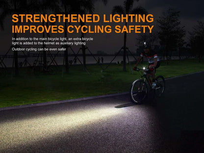 Cyclist riding on the road in the night using a bike light attached to a bike helmet with a promotional text. 