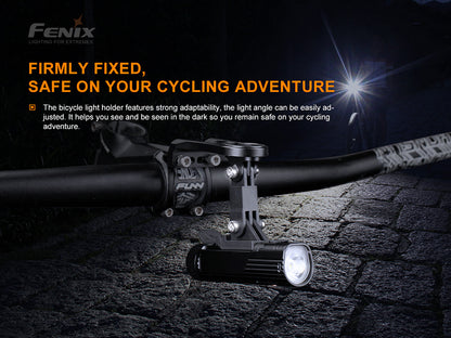Quick Release Bike Mount with GOPRO mount adapter attached to bike handlebar with a mountain biker riding a paved road in the night. 