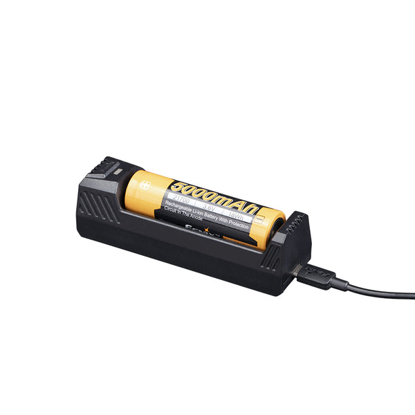 A black single-slot battery charger with a yellow battery on top and a USB Type-C cable attached.