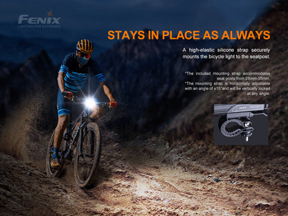 Biker on a dirt trail with text about a bicycle light mounting strap, featuring the Fenix brand.