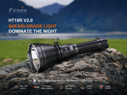 Fenix HT18R V2.0 flashlight on a rock with scenic background