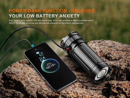 Fenix LR50R V2.0 Flashlight as a power bank charging a smartphone on a rock with outdoor background