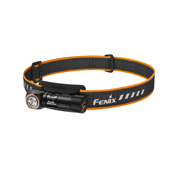 A black Fenix HM23 V2.0 headlamp with an orange strap and built-in LED light source.
