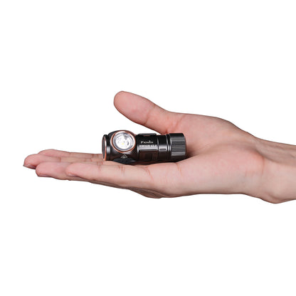 Hand holding Fenix HM50R V2.0 Headlamp in a flashlight mode. 
