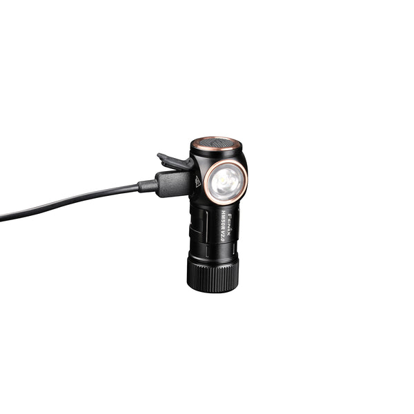 Fenix HM50R V2.0 Headlamp in a flashlight mode with an USB C cable attached. 