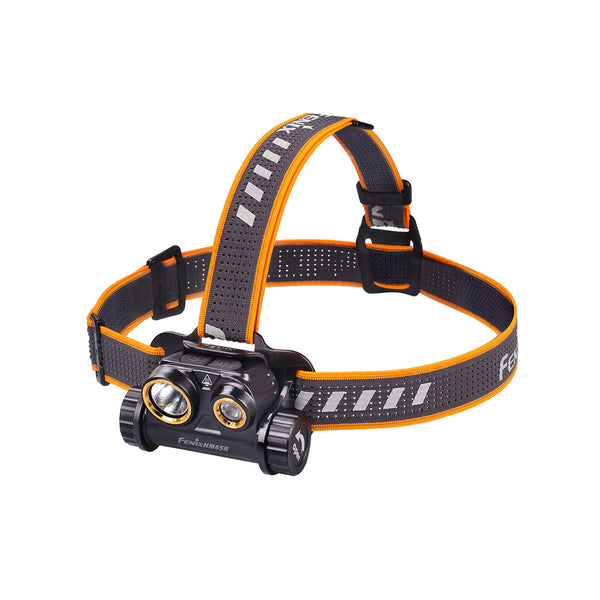 A black Fenix HM65R headlamp with an orange adjustable strap and white light emitters, designed for hands-free illumination.