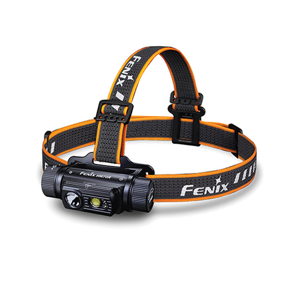 A black Fenix HM70R headlamp with an orange and black adjustable strap, featuring a LED light source and control buttons.